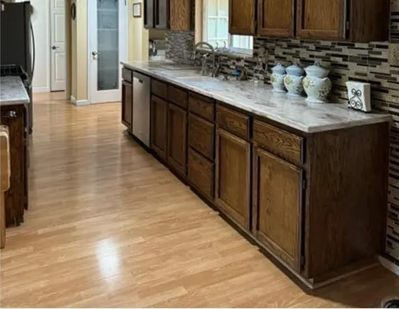 a kitchen with stainless steel appliances a sink stove and a wooden cabinets