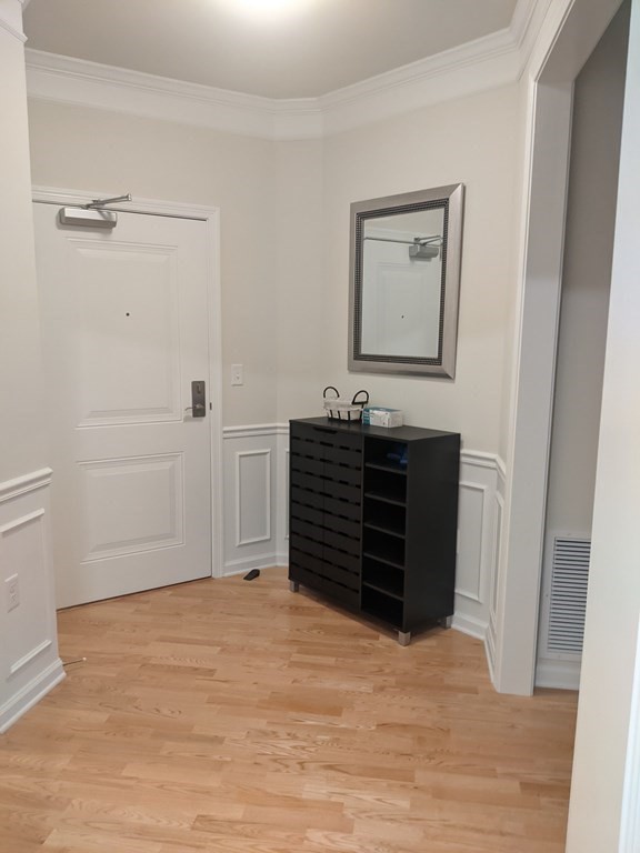 70 Trotter Road, Unit 312 Weymouth, MA 02190 - Photo 7 of 18 a view of an empty room with wooden floor