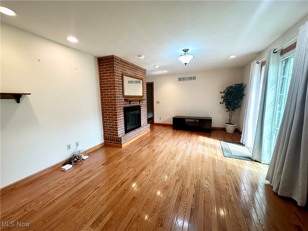 4461 Cross Creek Road Colliers, WV 26035 - Photo 20 of 33 Family room area with a brick fireplace, and light wood-style floors