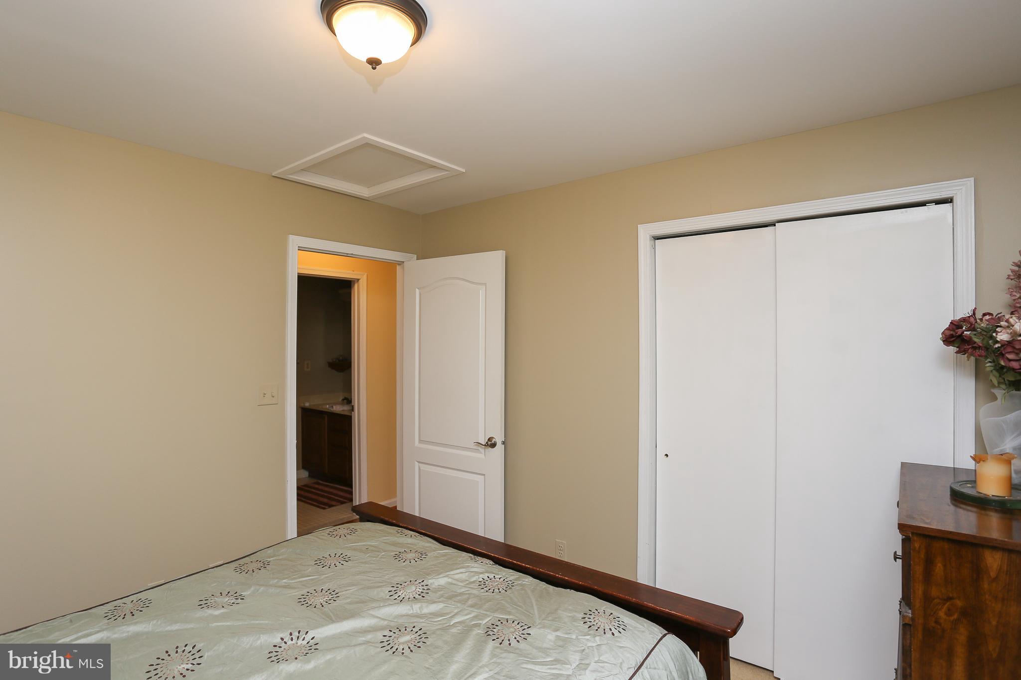 8276 Mission Road Jessup, MD 20794 - Photo 22 of 30 a bedroom with a bed and a chandelier