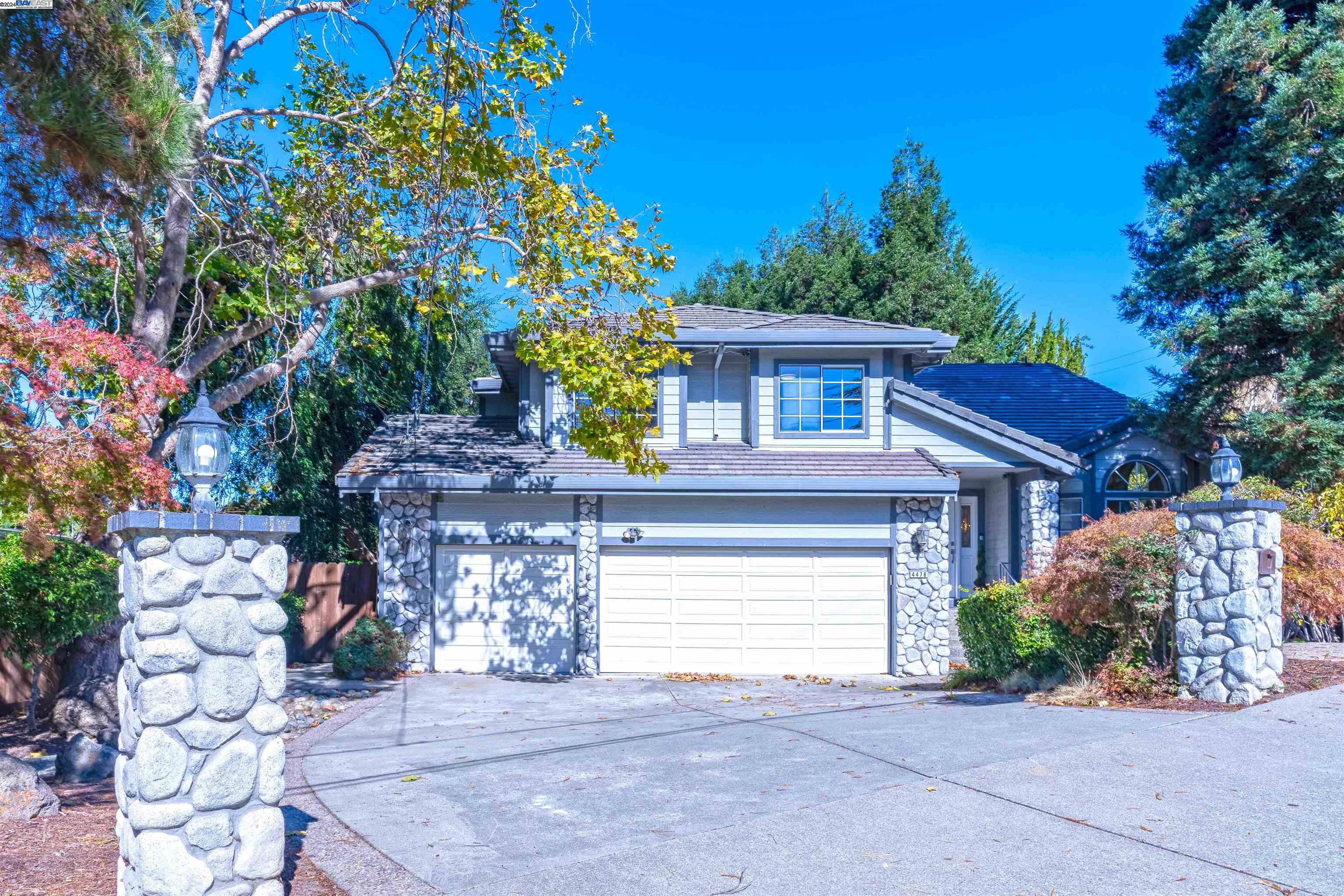 a view of a house with a tree and a yard