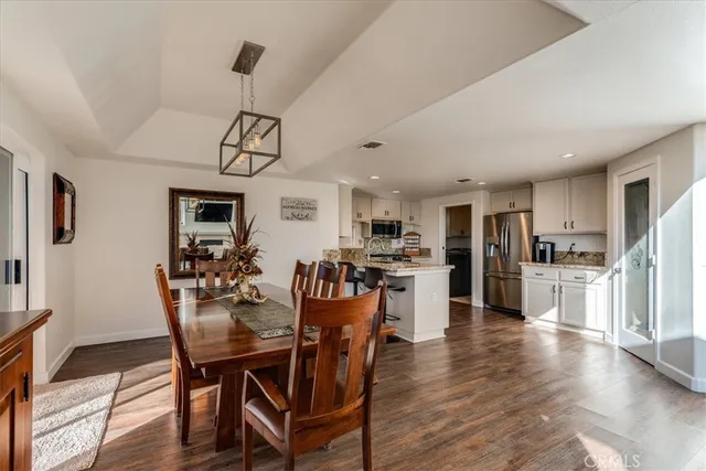 a kitchen with stainless steel appliances granite countertop a stove and a sink with white cabinets