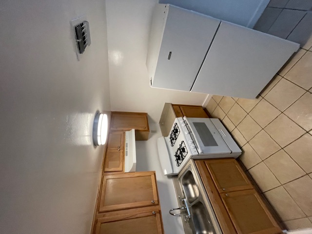 3411 Lyons Road Austin, TX 78702 - Photo 5 of 12 a kitchen with a stove and a refrigerator