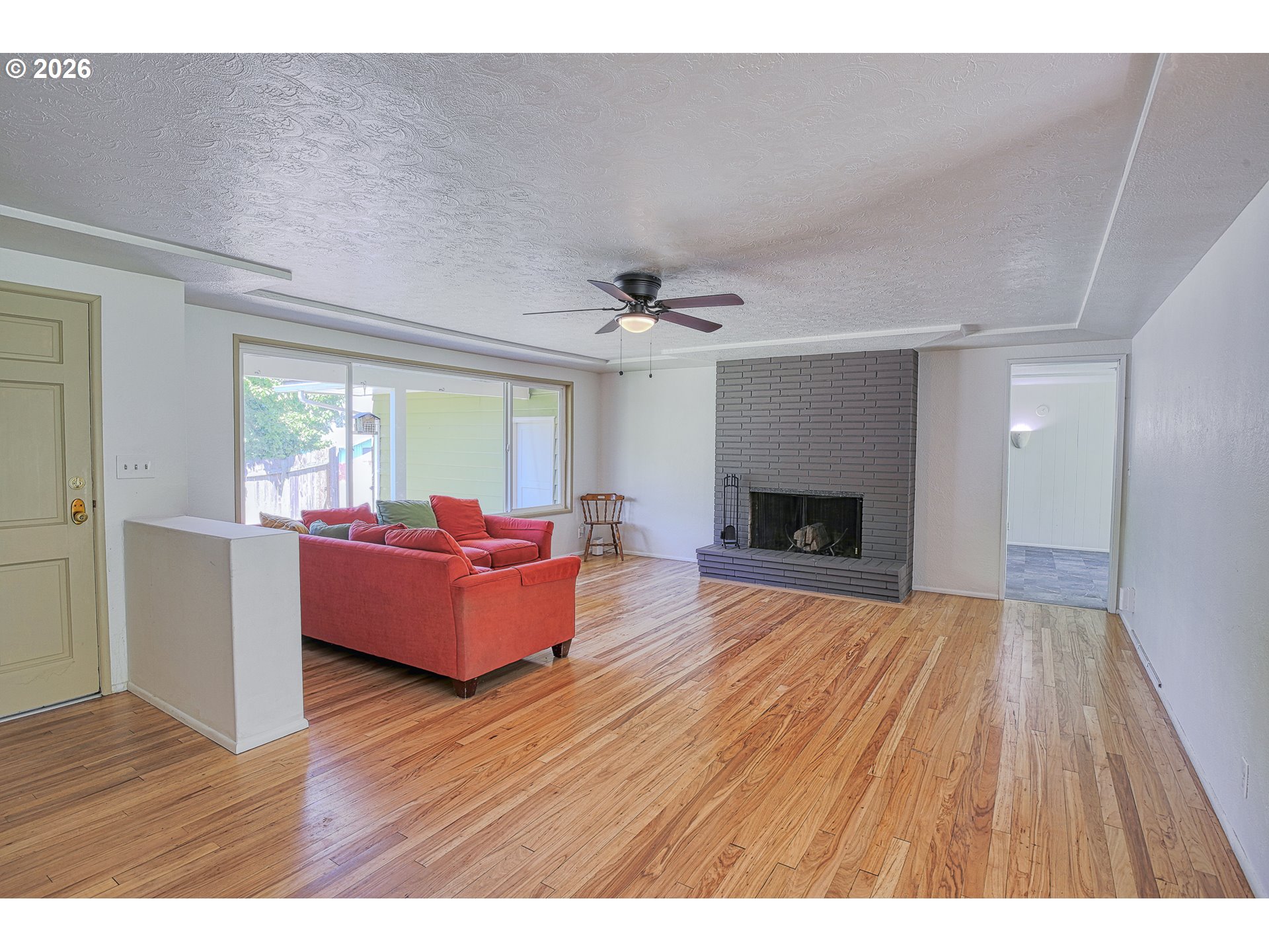 7077 Main Street Springfield, OR 97478 - Photo 3 of 34 a living room with furniture and a fireplace