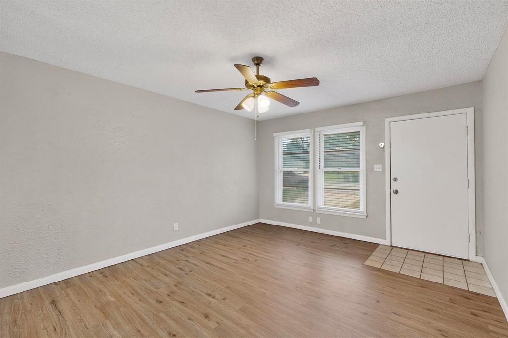 4508 Rutland Avenue Fort Worth, TX 76133 - Photo 7 of 36 a view of a room with wooden floor and a ceiling fan