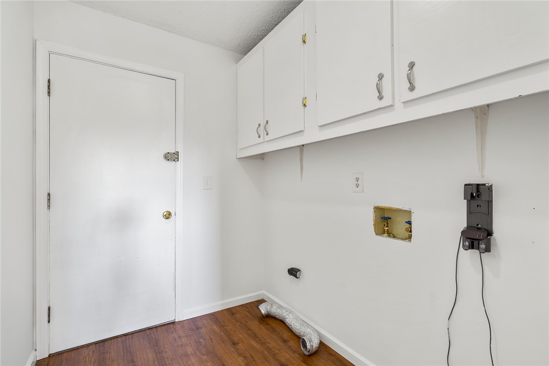 2305 Millgate Road Anderson, SC 29621 - Photo 16 of 18 Ample storage solutions and durable wood flooring characterize this practical laundry area.