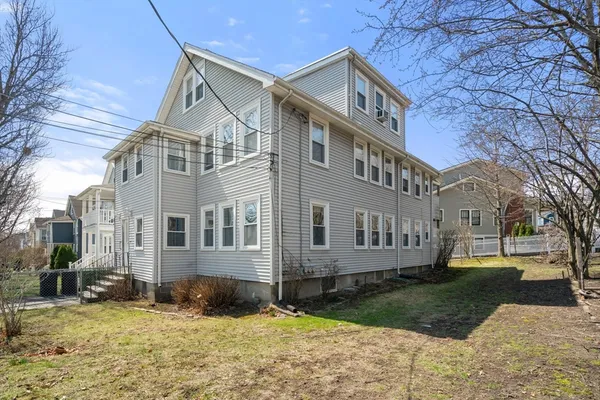a view of a big house with a yard