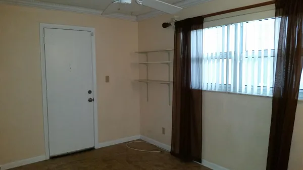 a view of an empty room with a window