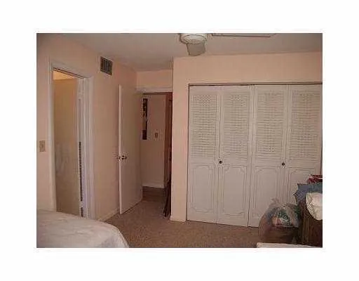 a living room with a bed and a walk in closet