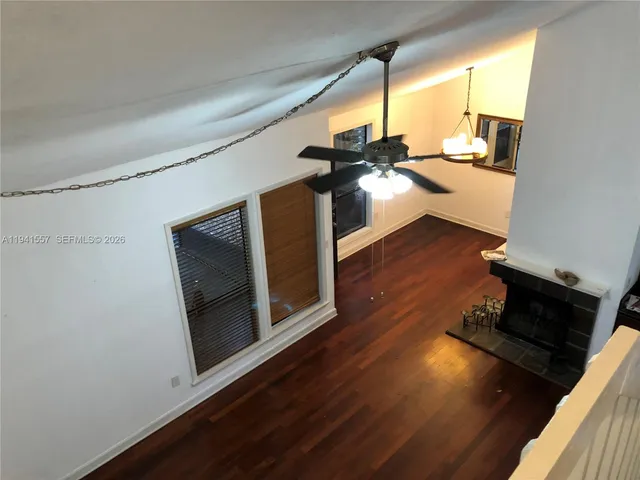 a living room with wooden floor and furniture