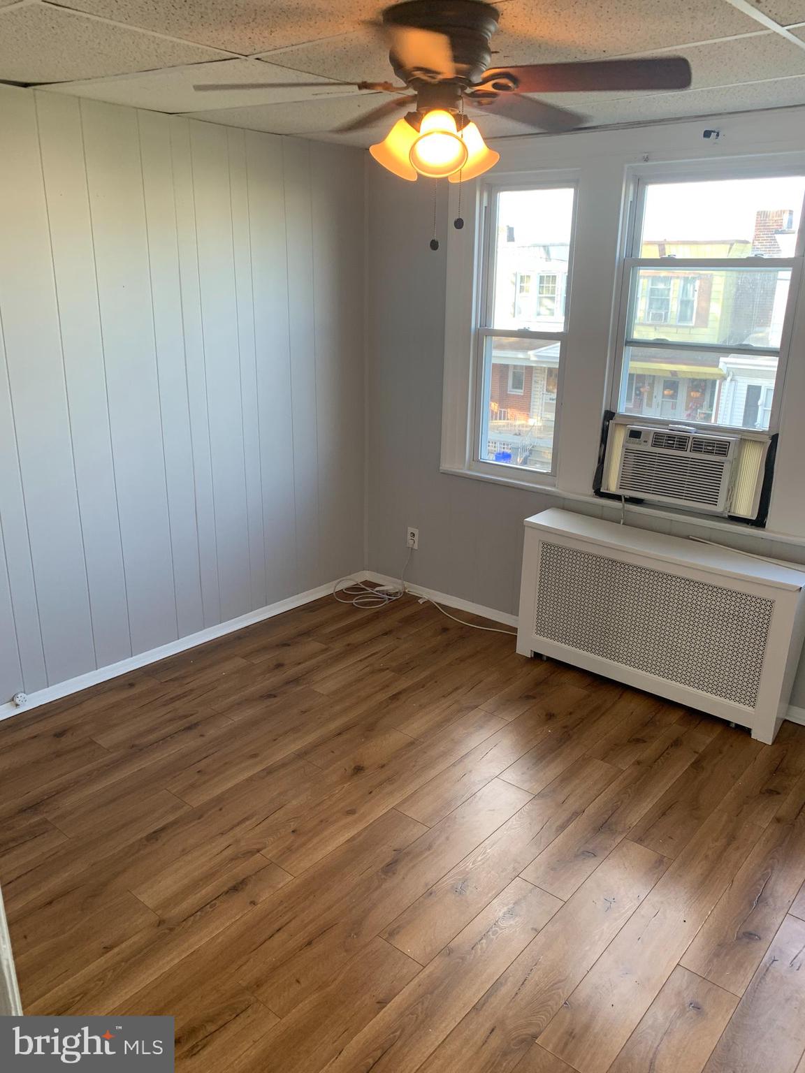 4135 Gilham Street Philadelphia, PA 19135 - Photo 11 of 12 a view of a living room with hardwood floor and a ceiling fan