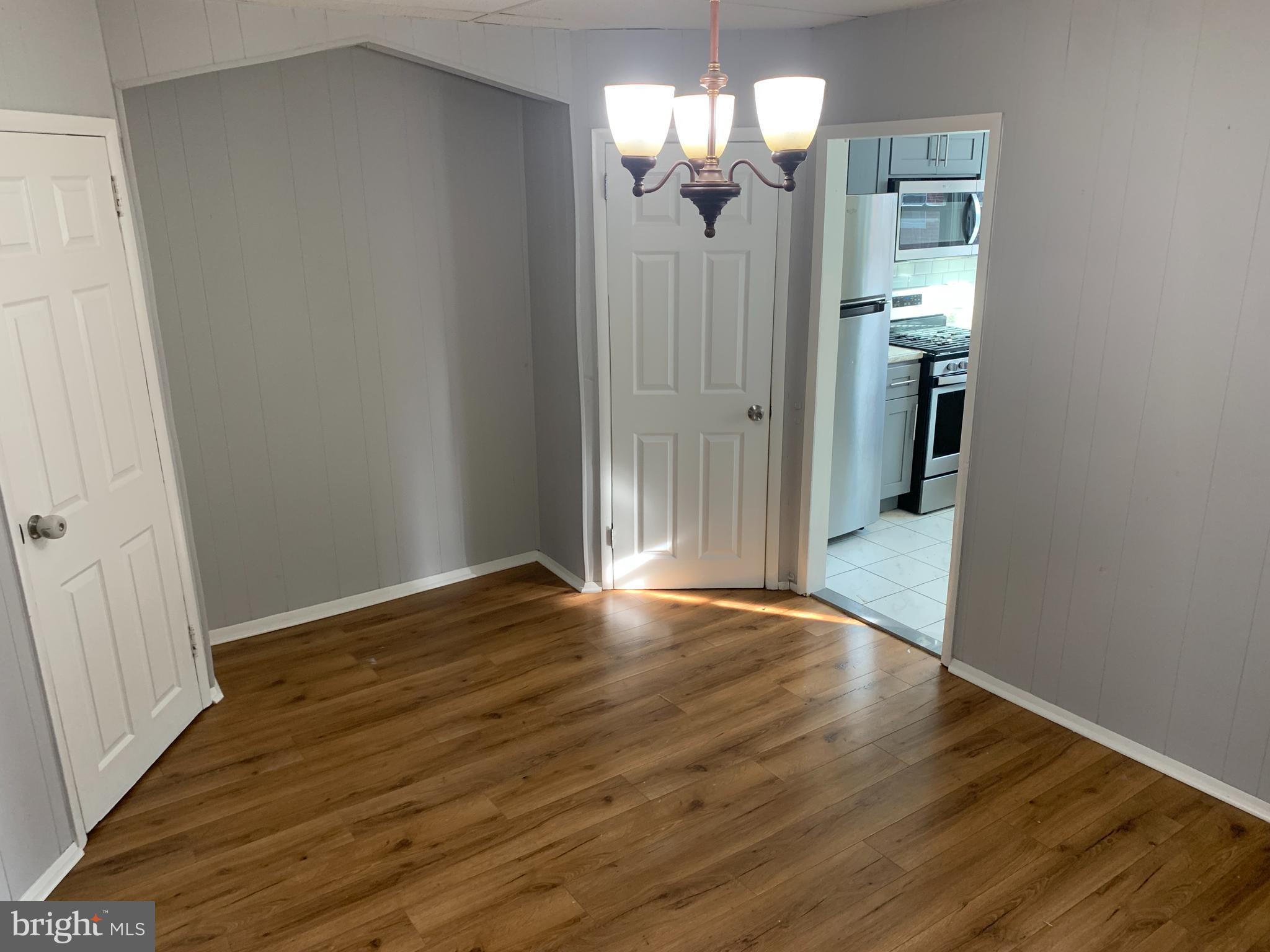 4135 Gilham Street Philadelphia, PA 19135 - Photo 4 of 12 a view of empty room with wooden floor