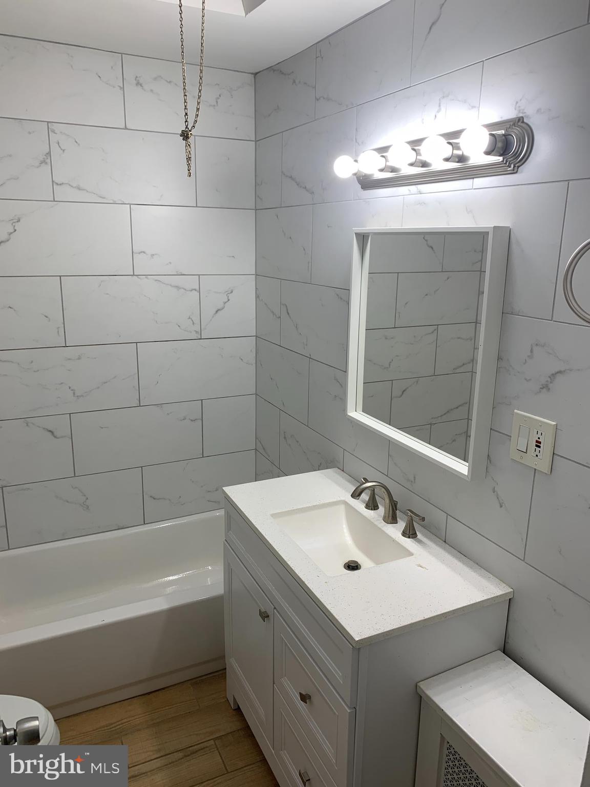 4135 Gilham Street Philadelphia, PA 19135 - Photo 6 of 12 a bathroom with a sink double vanity and a mirror