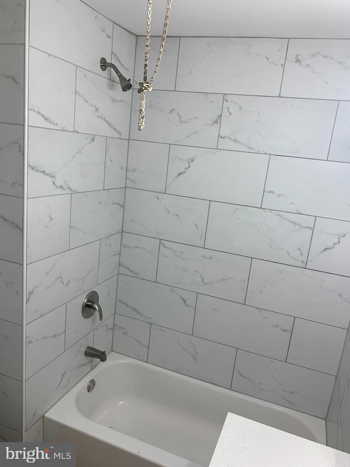 4135 Gilham Street Philadelphia, PA 19135 - Photo 7 of 12 a bathroom with a bathtub