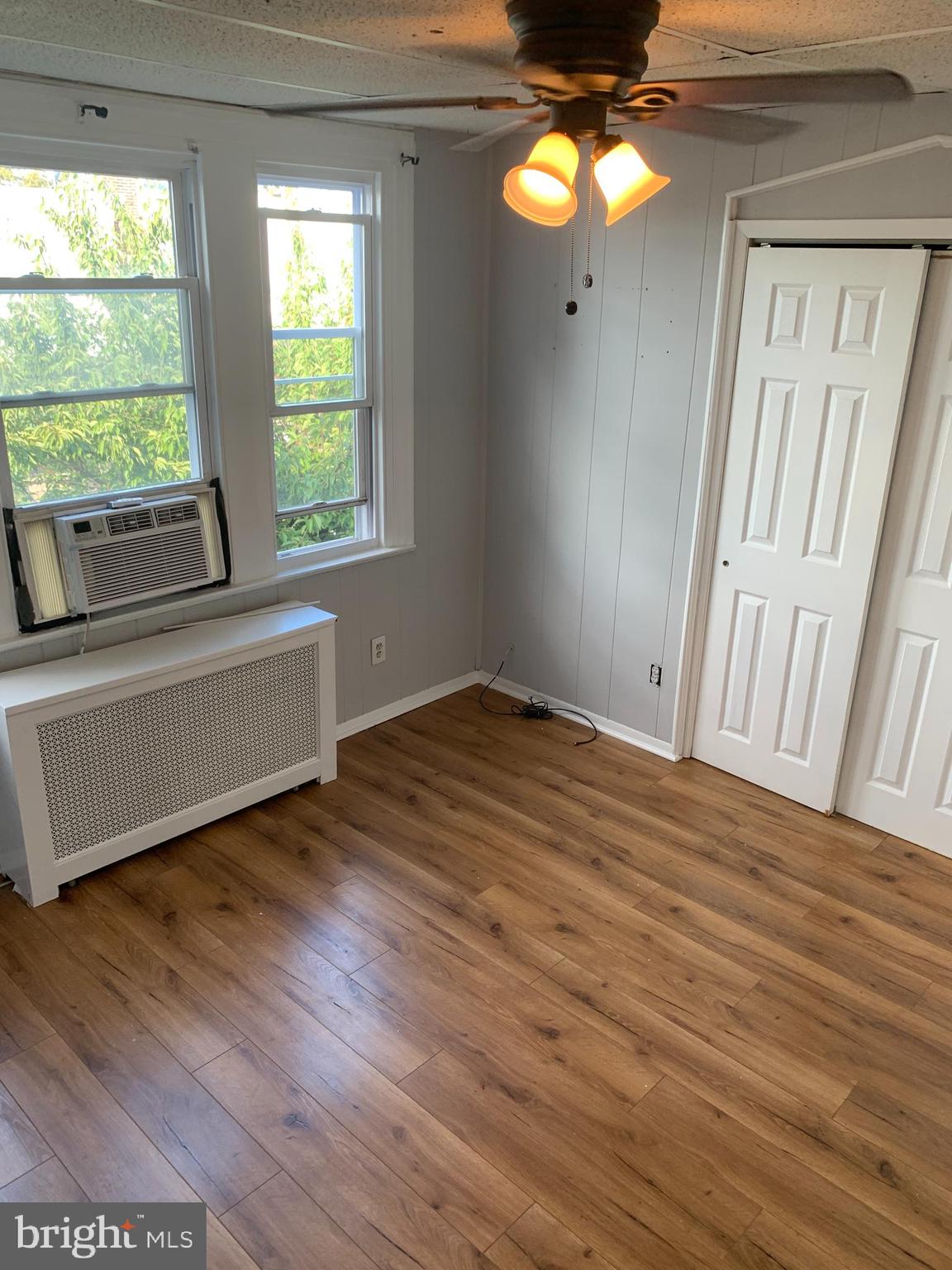 4135 Gilham Street Philadelphia, PA 19135 - Photo 8 of 12 a view of empty room with wooden floor and fan