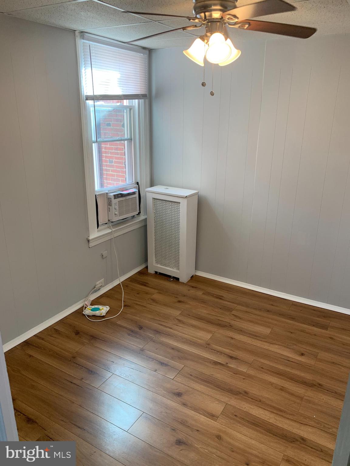 4135 Gilham Street Philadelphia, PA 19135 - Photo 9 of 12 wooden floor in an empty room with a window