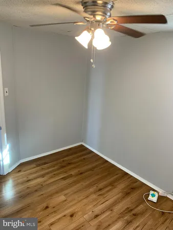 a view of a small space with wooden floor cabinets and a painting