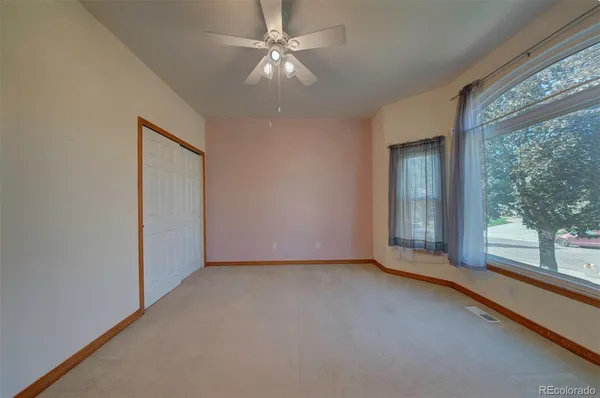 an empty room with windows and entrance