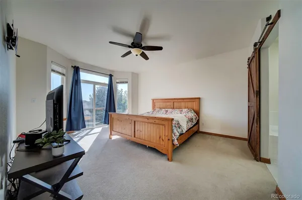 a bed room with a bed window and a chair