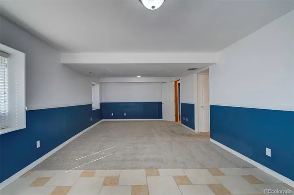 a view of empty room with a fireplace and window