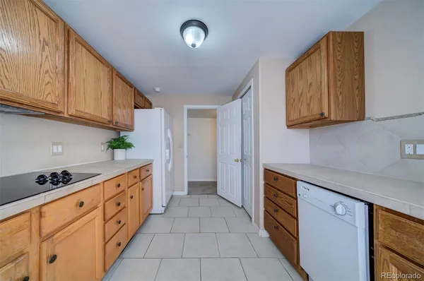a kitchen with granite countertop a sink a stove and cabinets