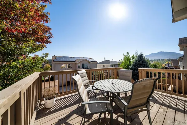 a view of a chairs and table on the roof deck