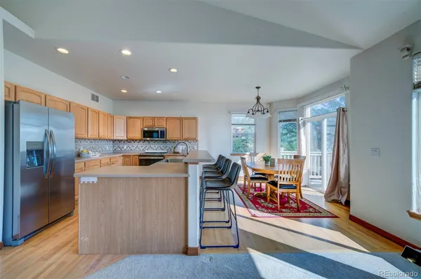 a kitchen with stainless steel appliances granite countertop a stove and a refrigerator