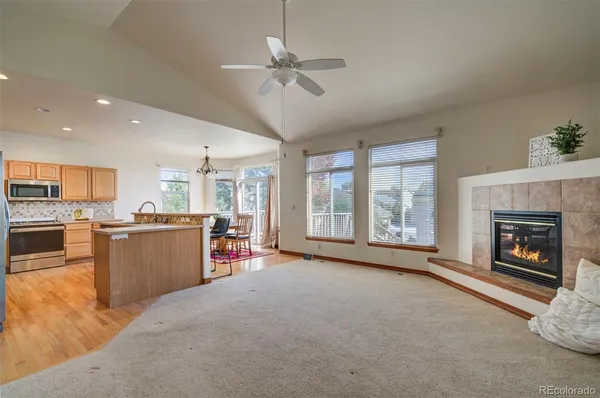 a view of a room with kitchen and fireplace