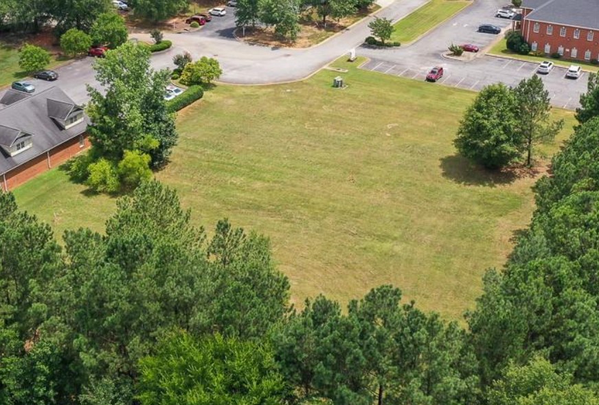 120 Perpetual Square Drive Anderson, SC 29621 - Photo 5 of 14 A spacious, verdant lot awaits your vision, bordered by established trees and a paved access road.