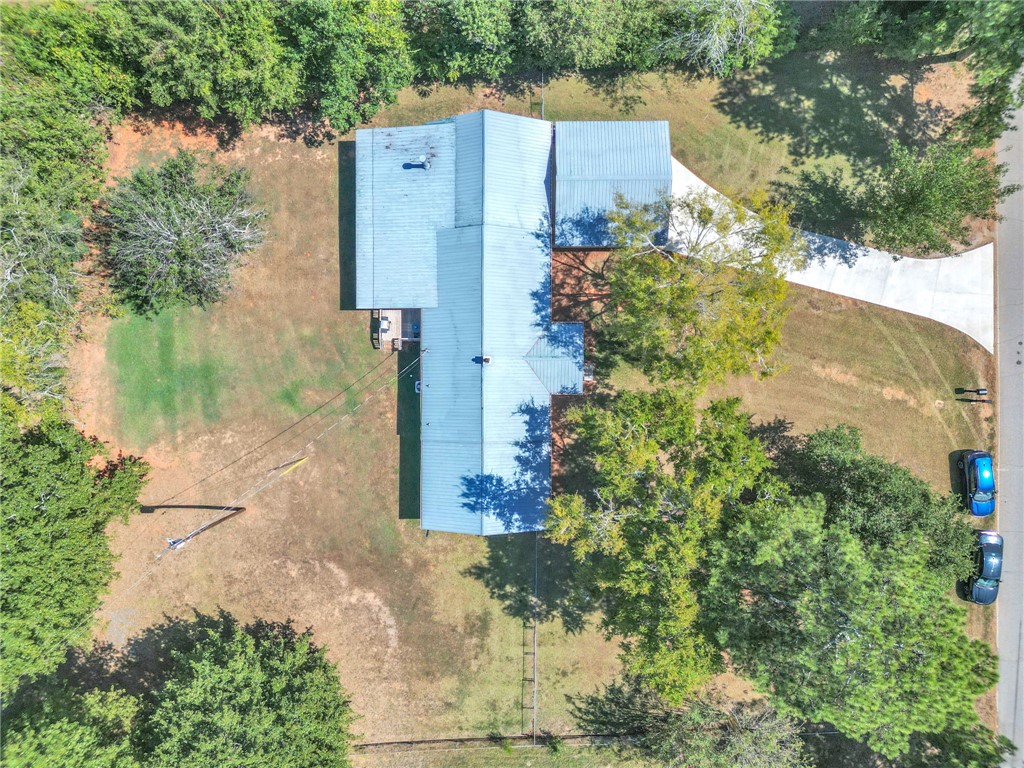 1048 Old Gantt Mill Road Anderson, SC 29625 - Photo 28 of 30 Mature trees surround this spacious property featuring a metal roof and concrete driveway.