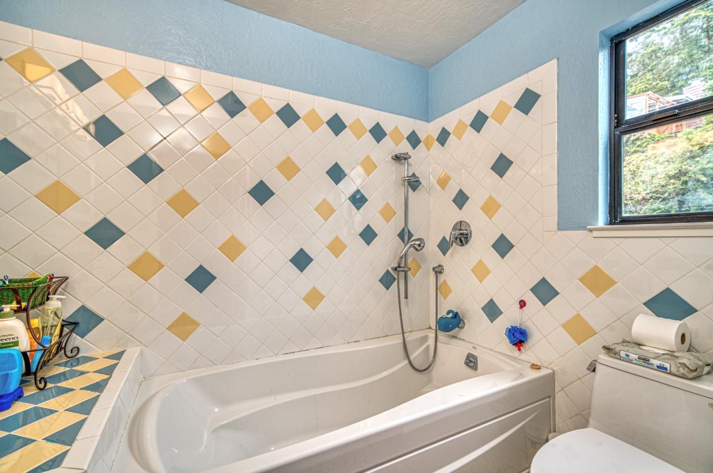 923 Linda Mar Boulevard Pacifica, CA 94044 - Photo 16 of 31 a bathroom with a bathtub and a shower curtain