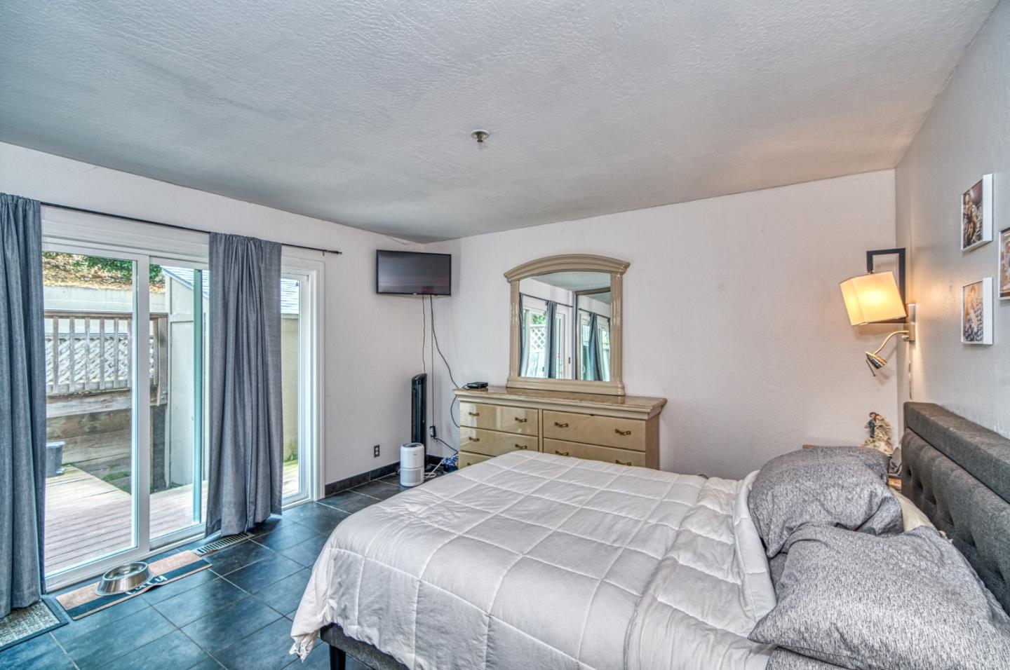 923 Linda Mar Boulevard Pacifica, CA 94044 - Photo 17 of 31 a bedroom with a bed and wooden floor