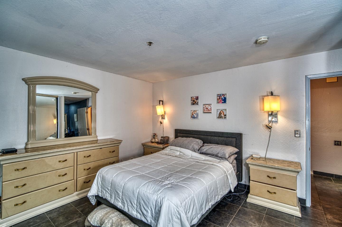 923 Linda Mar Boulevard Pacifica, CA 94044 - Photo 18 of 31 a bedroom with a bed and a large mirror on the dresser