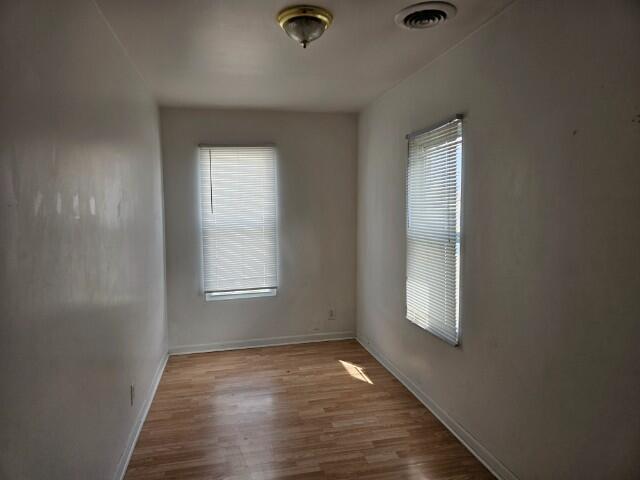 5421 West Main Street Monee, IL 60449 - Photo 11 of 13 an empty room with wooden floor and windows