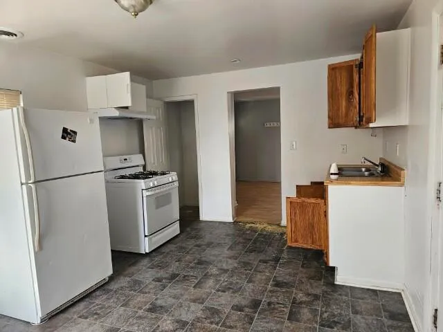 a kitchen with a refrigerator and a stove