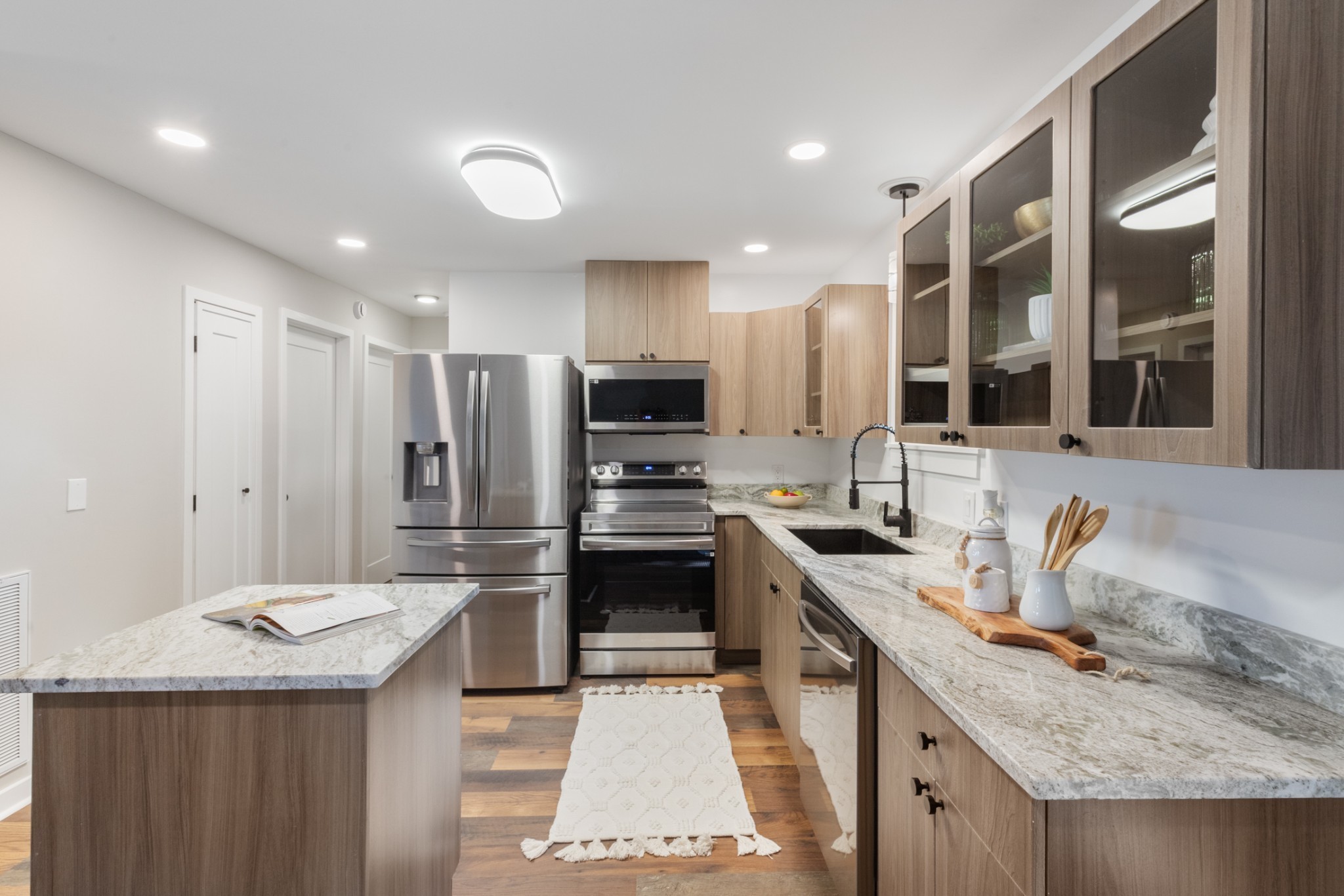 100 Short Street Dickson, TN 37055 - Photo 17 of 33 a kitchen with stainless steel appliances granite countertop a sink stove and refrigerator