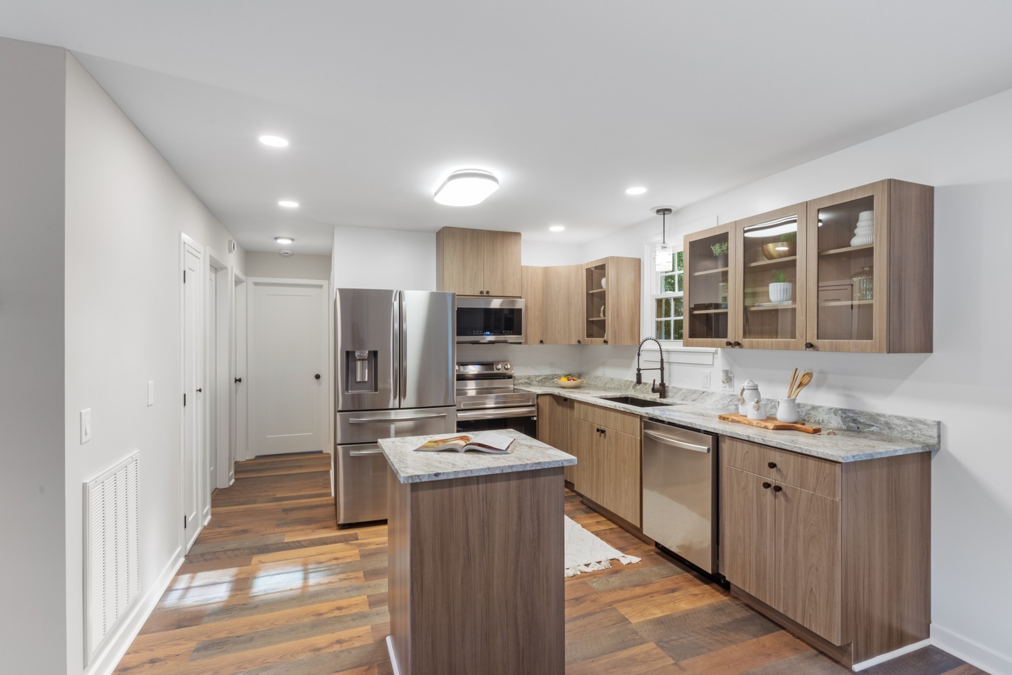 100 Short Street Dickson, TN 37055 - Photo 18 of 33 a kitchen with stainless steel appliances granite countertop a sink stove and refrigerator