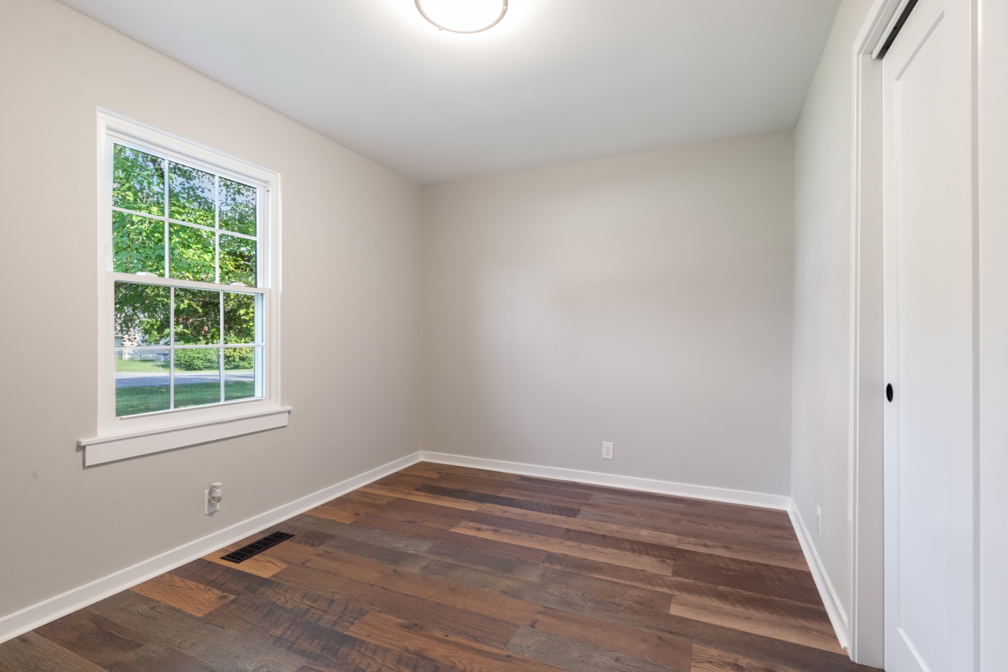 100 Short Street Dickson, TN 37055 - Photo 26 of 33 an empty room with wooden floor and windows