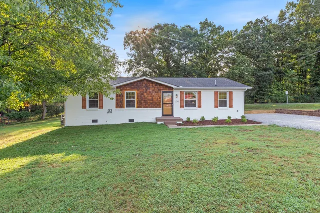 a view of a house with a backyard