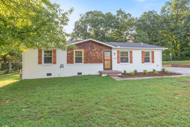 a front view of house with yard and green space