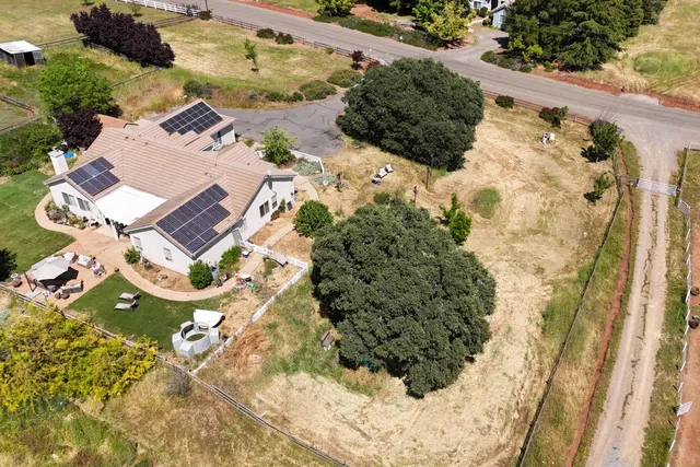 an aerial view of a house with a yard