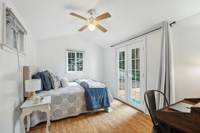 a bedroom with a bed and wooden floor