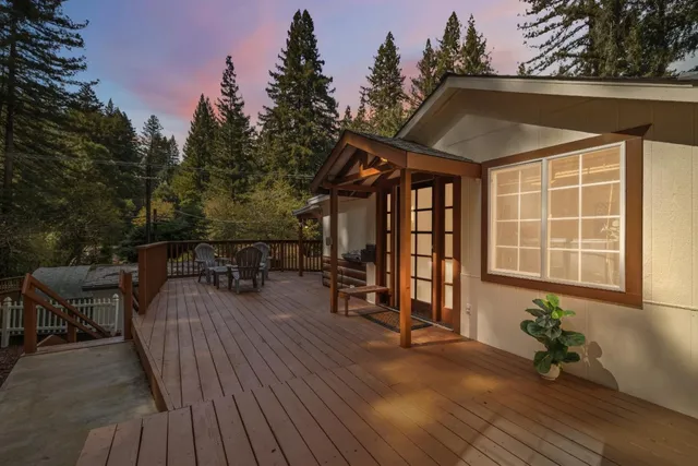 a backyard of a house with wooden floor and outdoor seating