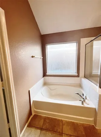a bathroom with a bathtub and a sink
