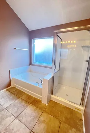 a bathroom with a tub and a shower