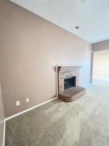 a view of an empty room with a fireplace