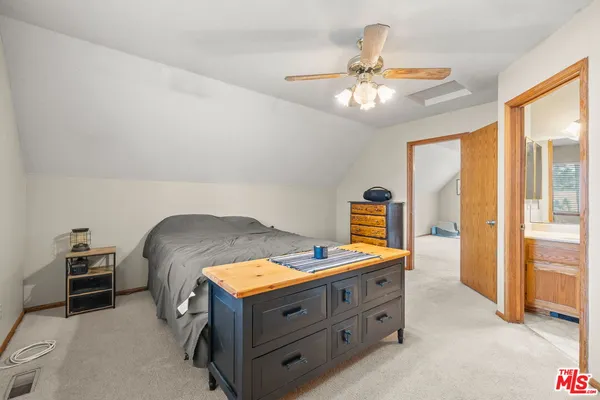 a bed room with a bed and a chandelier