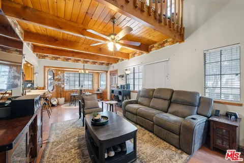 a living room with furniture a rug and a large window