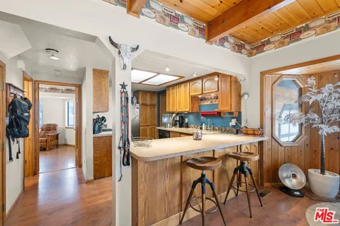 a view of a dining room with furniture large window and wooden floor