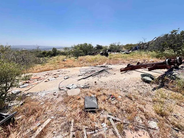 a wooden fence with some trees in the background